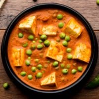 Green peas or matar paneer curry recipe, served in a bowl. selective focus